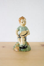 1957 Boy Sitting With Hat Ceramic Figurine