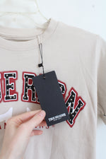 True Religion Tan T-Shirt With Black And Red Logo And Silver Studs